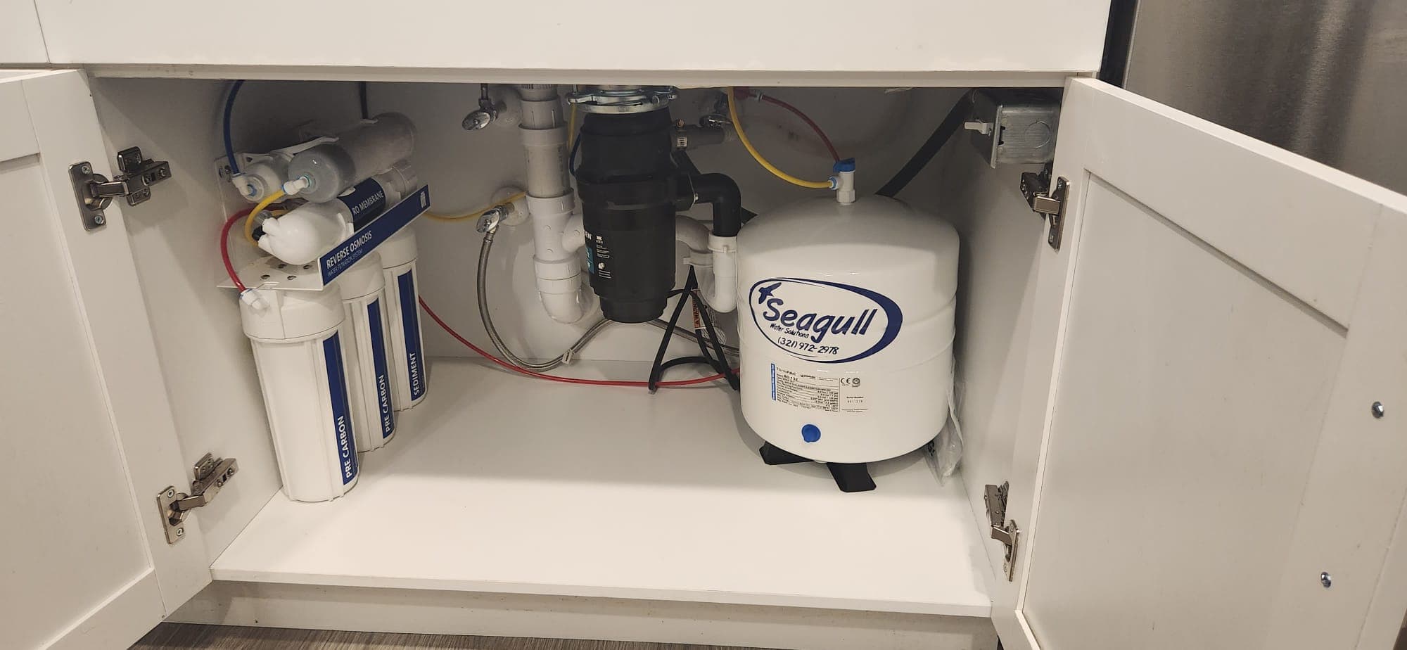 Alkaline reverse osmosis drinking water system under kitchen sink installed by Seagull Water Solutions in Orlando FL
